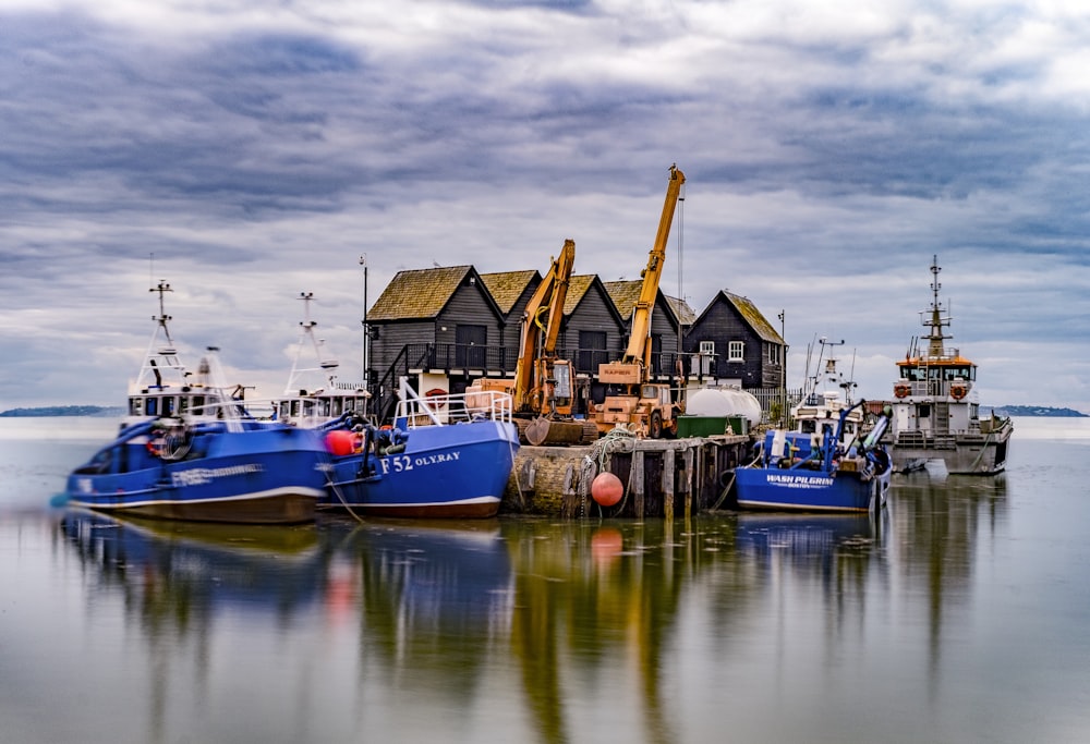 photograph of several boats near dock