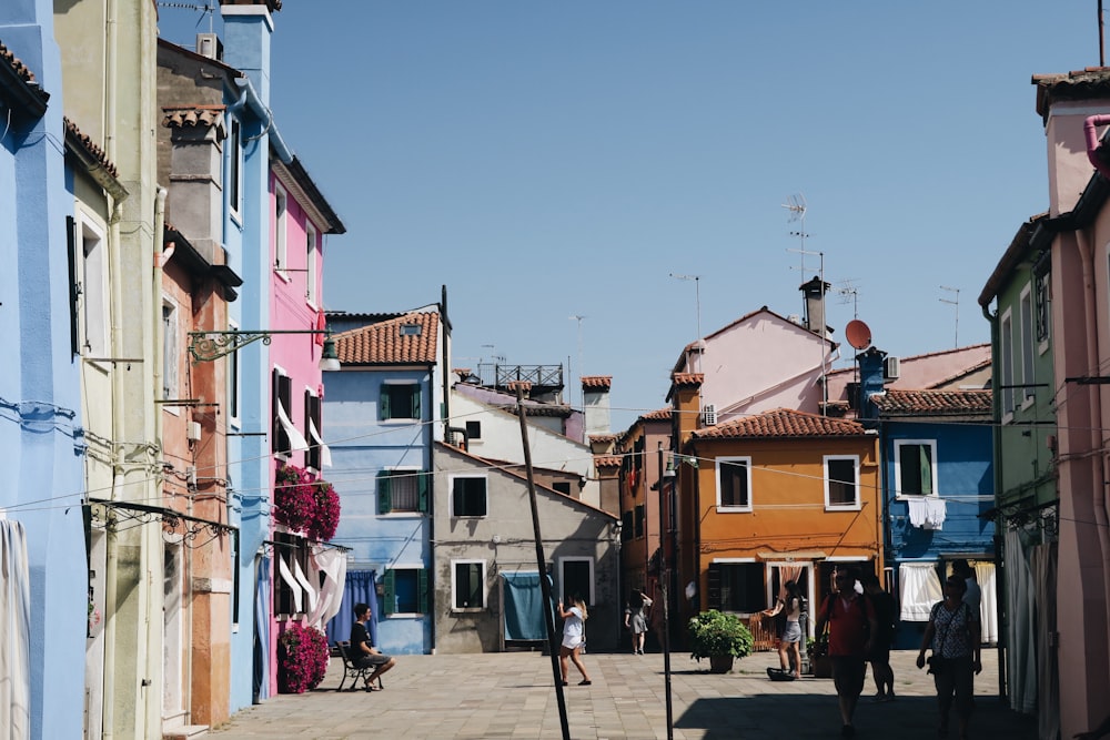 people standing outside houses