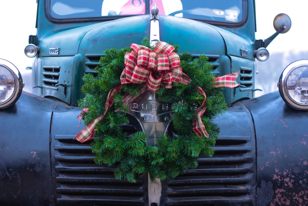 green wreath on bumper of blue truck
