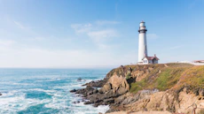 lighthouse in mountain next to ocean