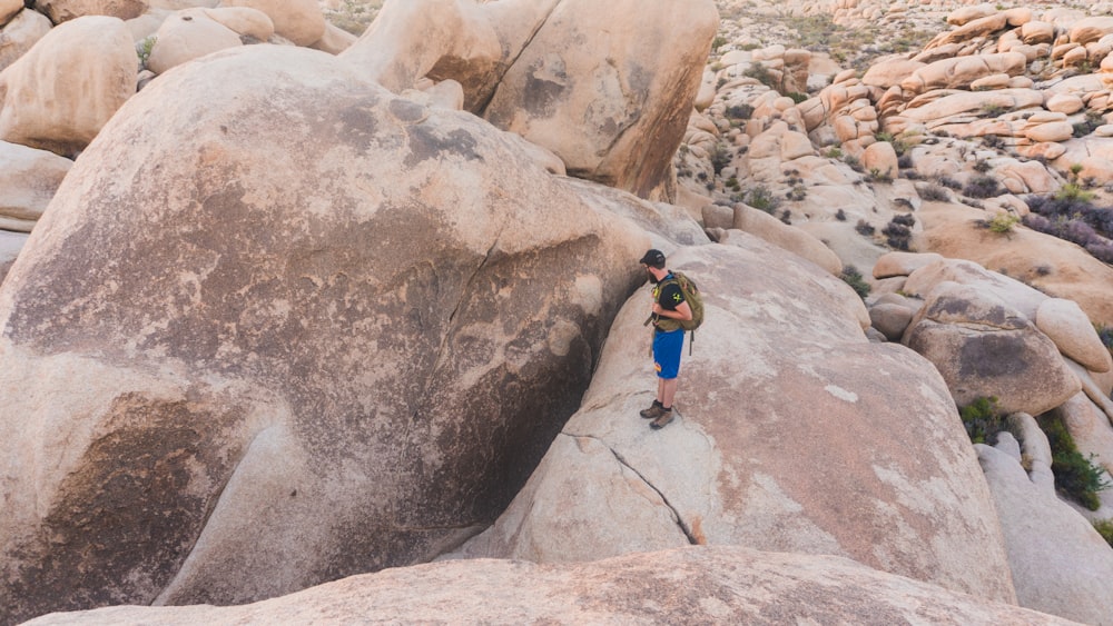 person standing on brown rock