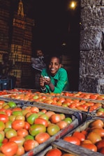 Young people working together packing fresh produce in a community store setting