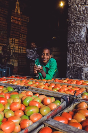 Young people working together packing fresh produce in a community store setting