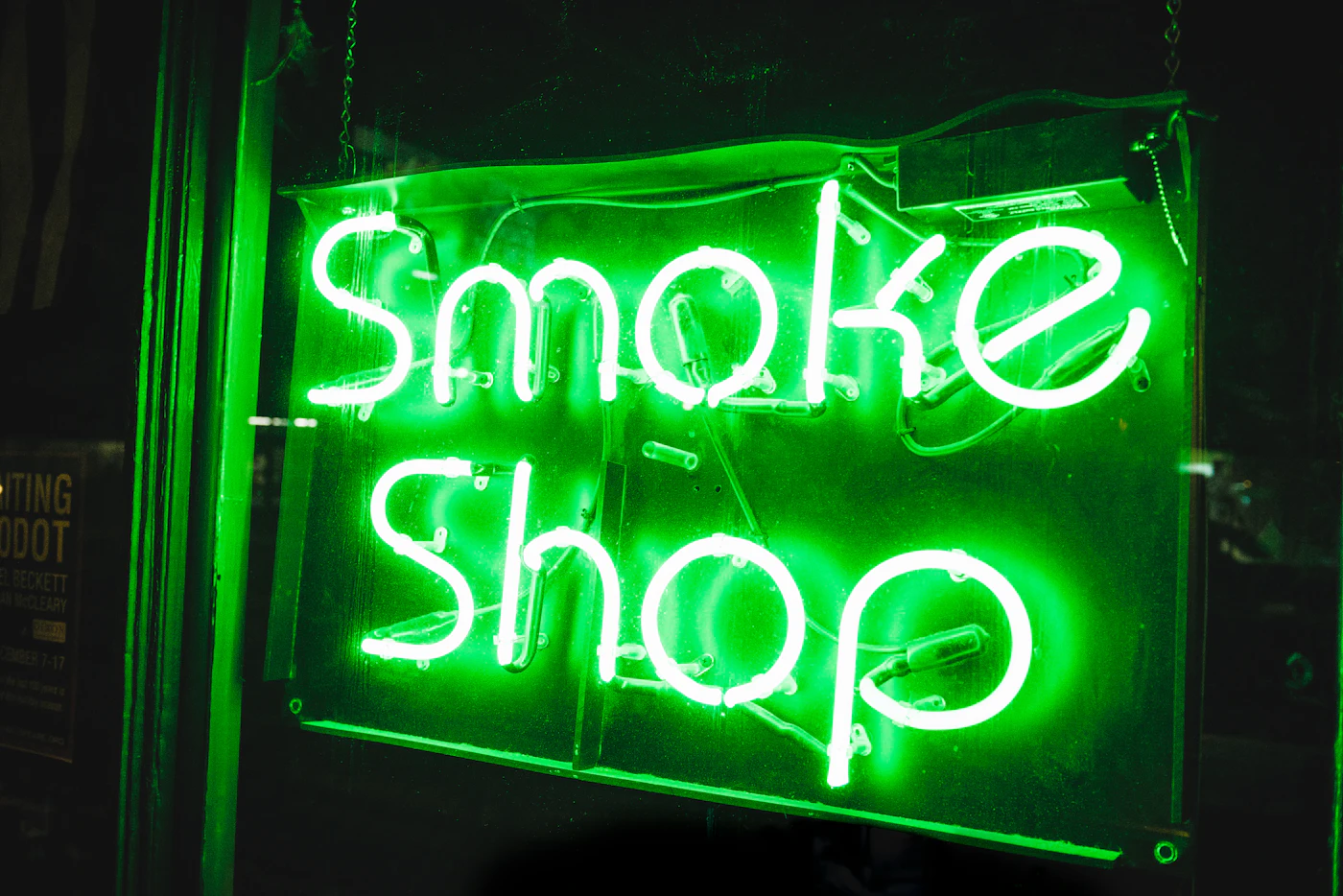 Neon smoke shop sign at night