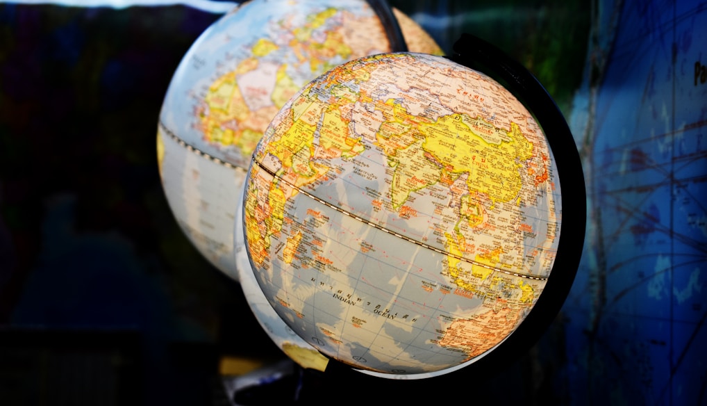 shallow focus photography of two desk globe