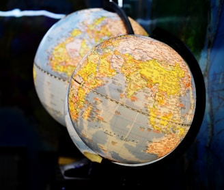 shallow focus photography of two desk globe