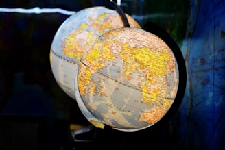 shallow focus photography of two desk globe