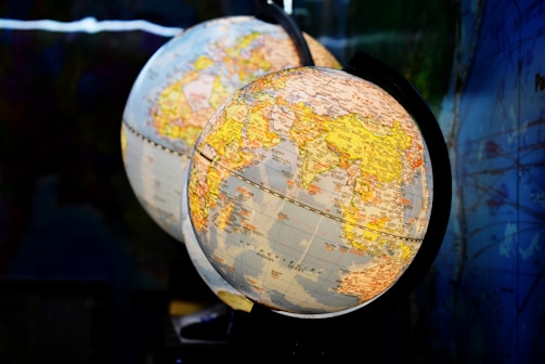 shallow focus photography of two desk globe