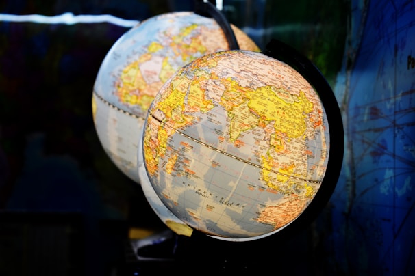 shallow focus photography of two desk globe