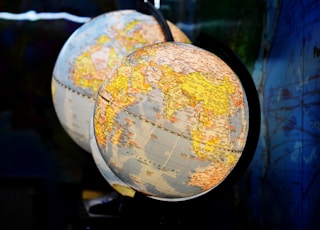 shallow focus photography of two desk globe