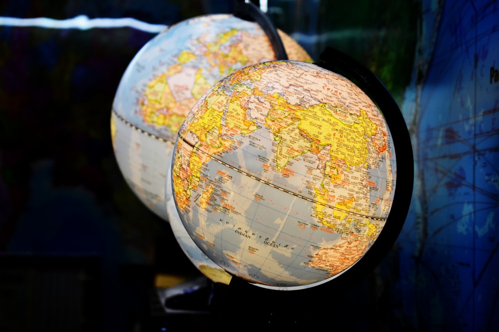 shallow focus photography of two desk globe