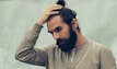man holding his black hair