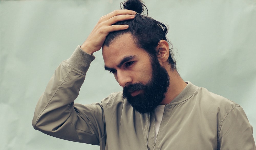 man holding his black hair