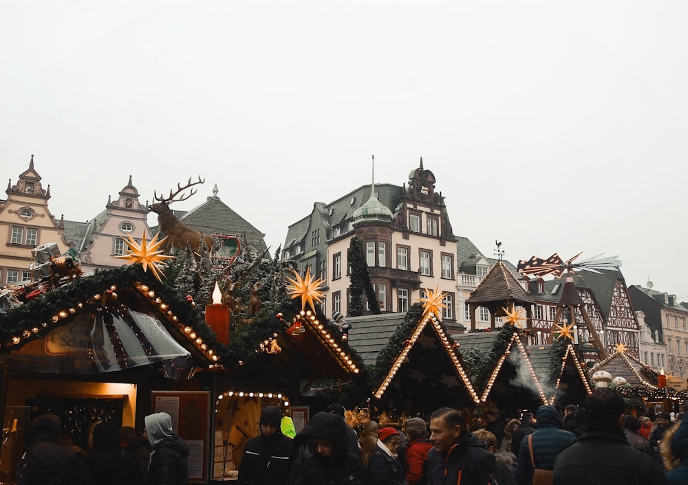 people passing by black and brown wooden structures