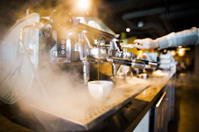 Artisanal espresso machine steaming fresh coffee in a cozy café setting.