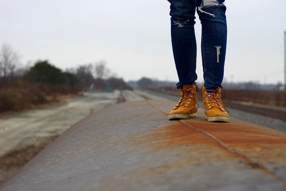 photo of person standing on gray metal container