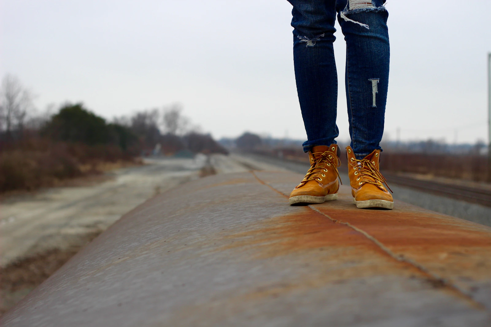 Wheat boots and jeans on road