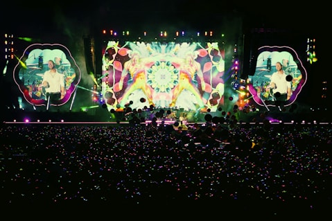 people standing in front of stage partying during nighttime