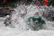 people in boat rowing raft