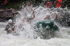 people in boat rowing raft