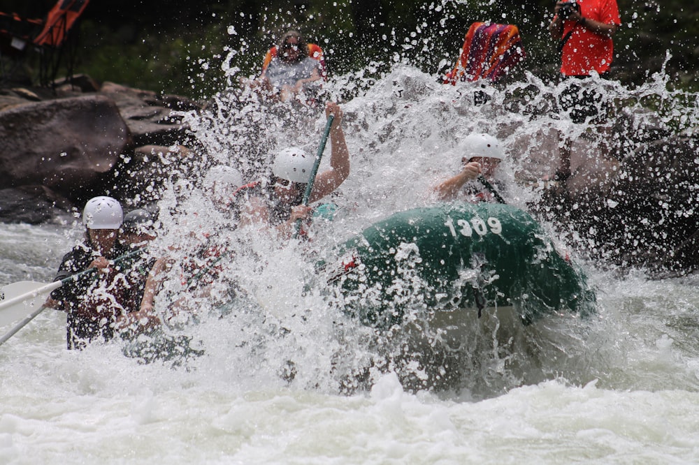 people in boat rowing raft