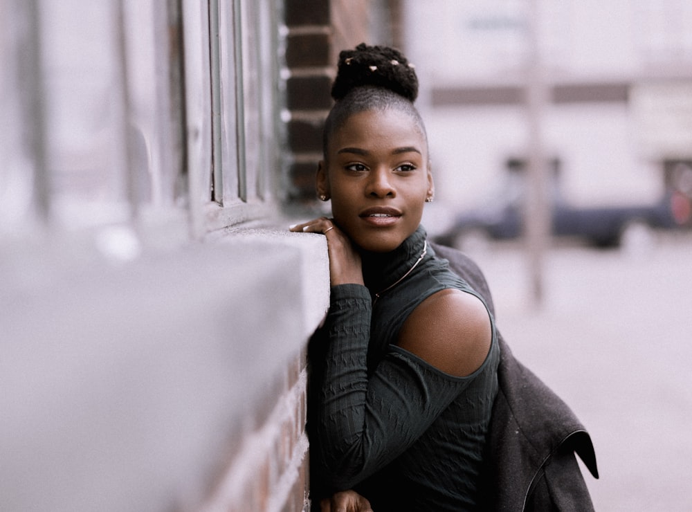 woman leaning on the wall