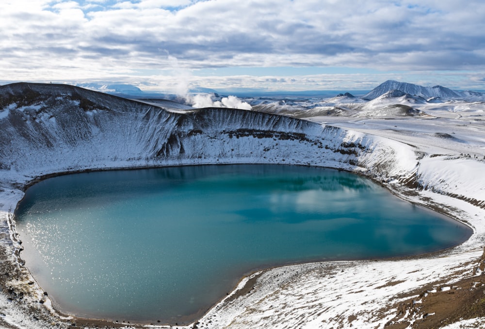 body of water near mountain during daytime