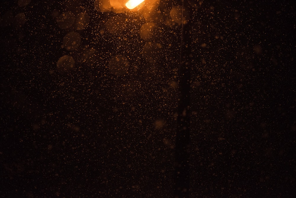 a street light in the dark on a snowy night