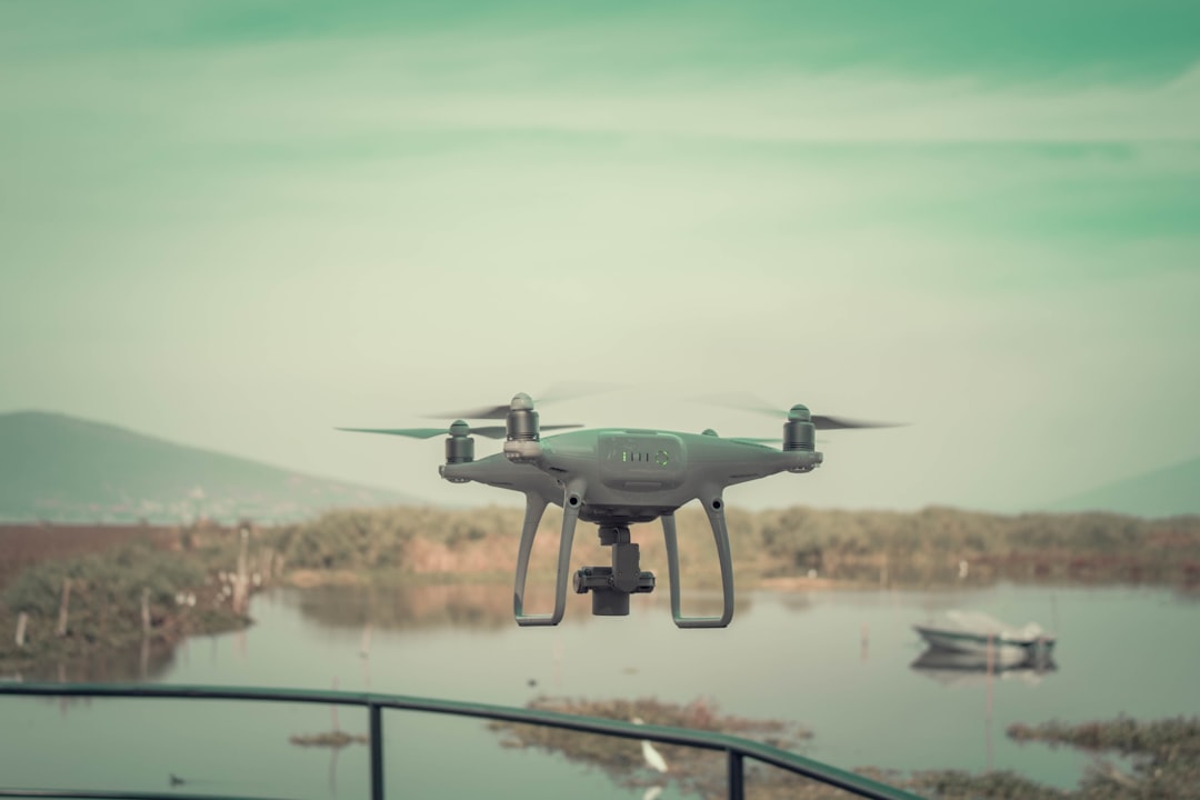 flying white drone quadcopter during daytime