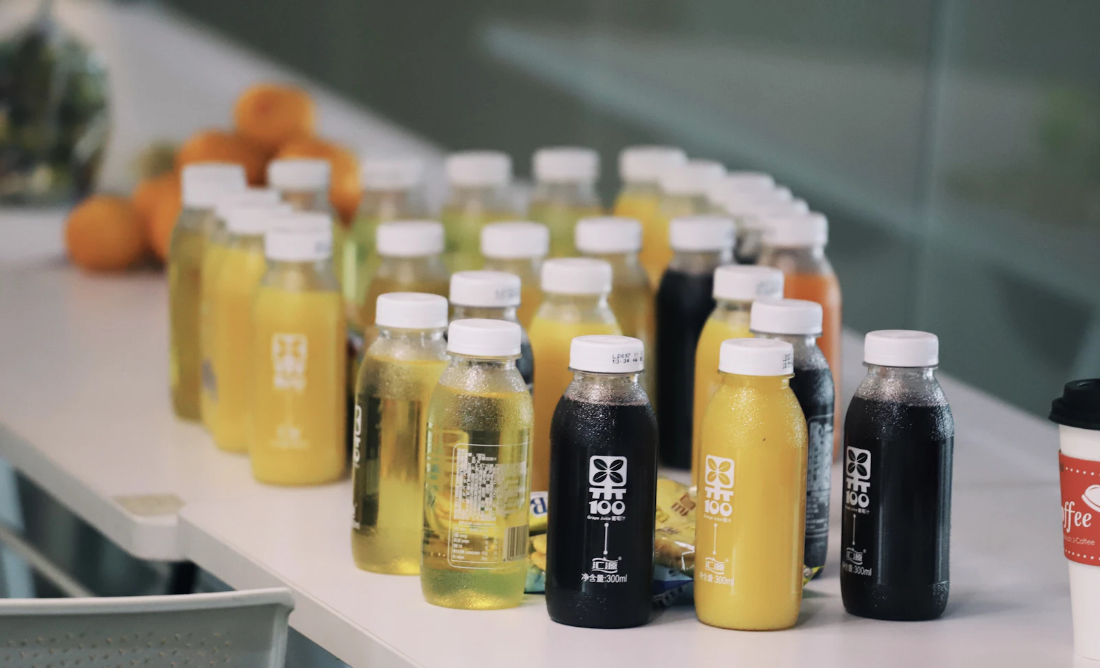 Clear glass juice bottles on a white table