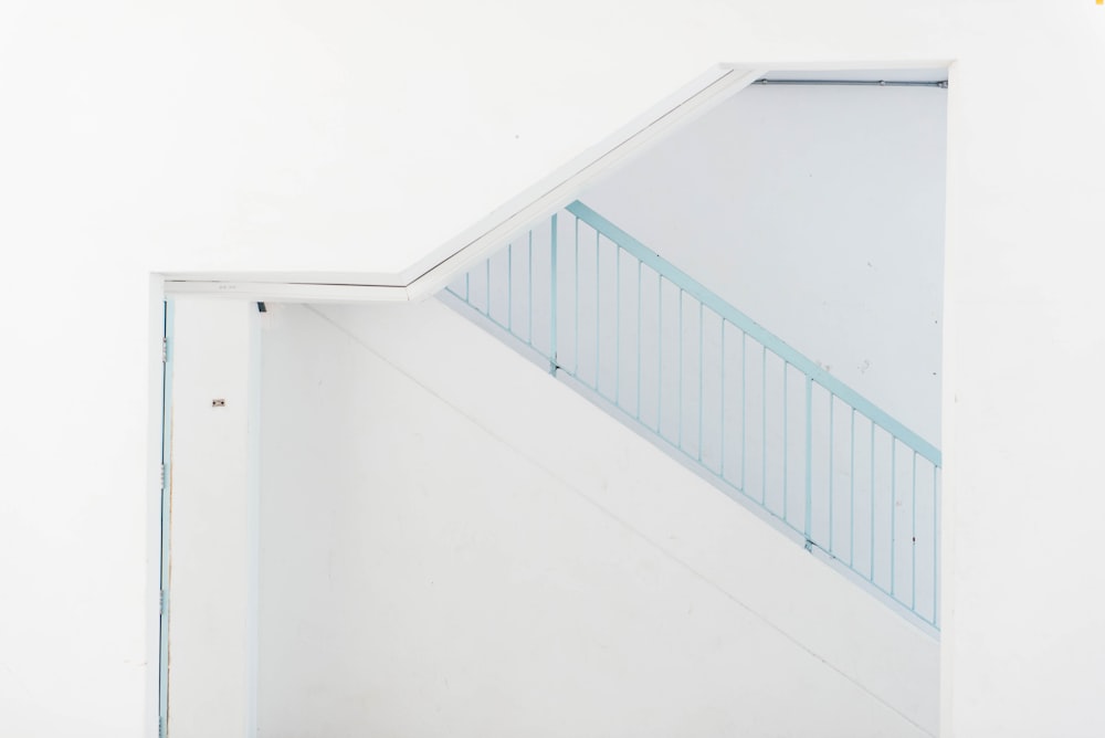 white wooden door beside blue stairs