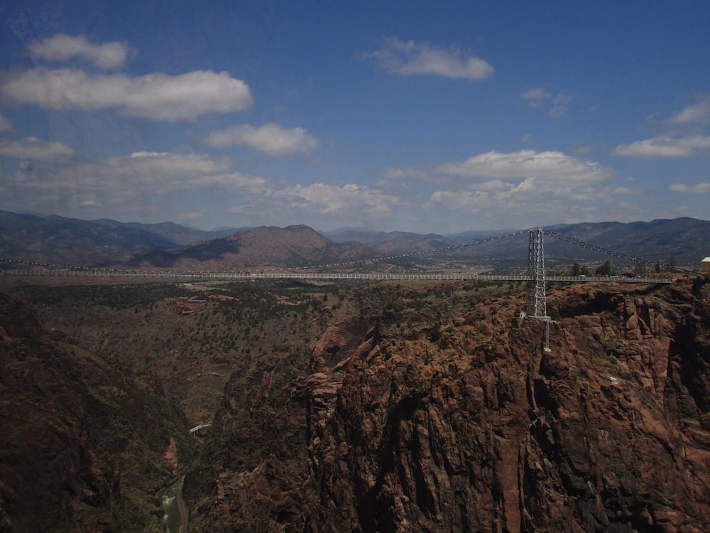 gray bridge overlooking mountain