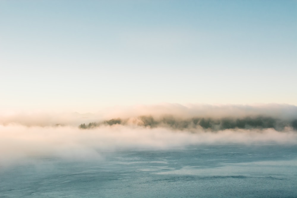 body of water under white clouds