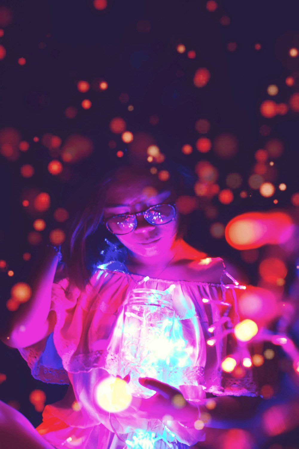 woman holding glass jar with bokeh light background