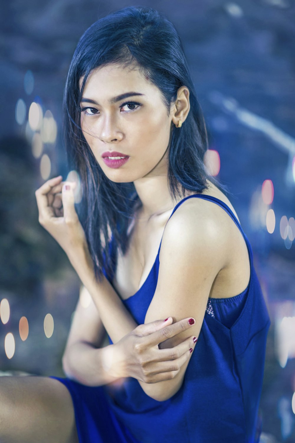 woman in blue spaghetti strap top bokeh photography