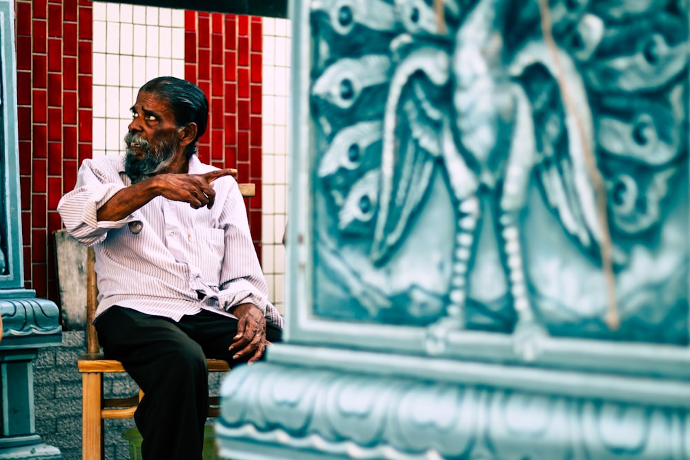 man sitting on chasir