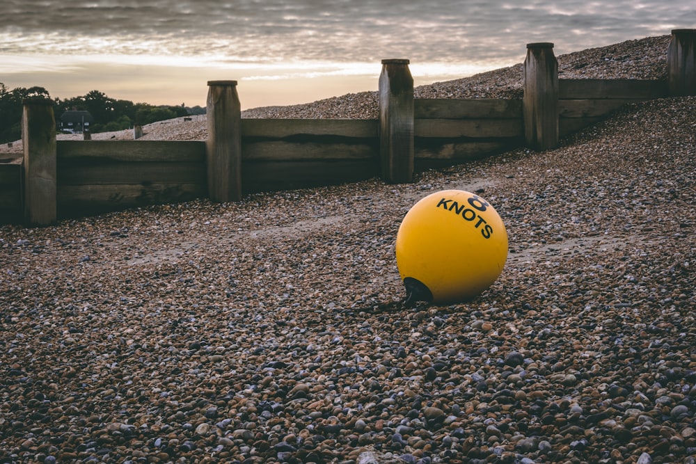 yellow 8 knots ball on pebble