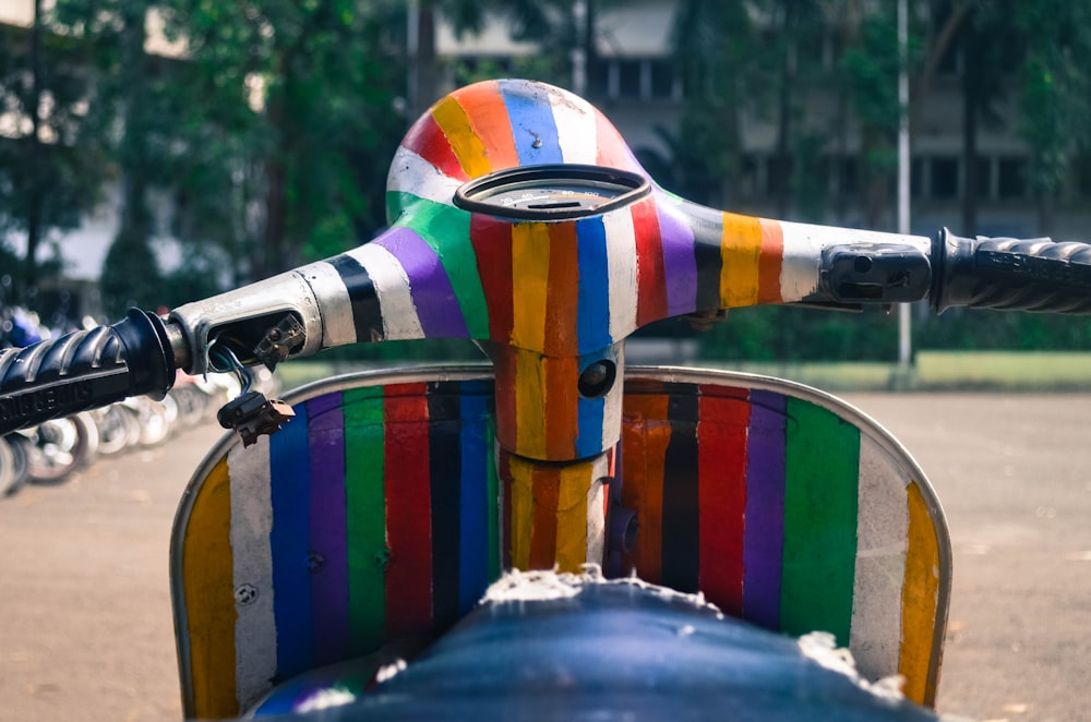 photo of red, orange, and yellow motor scooter