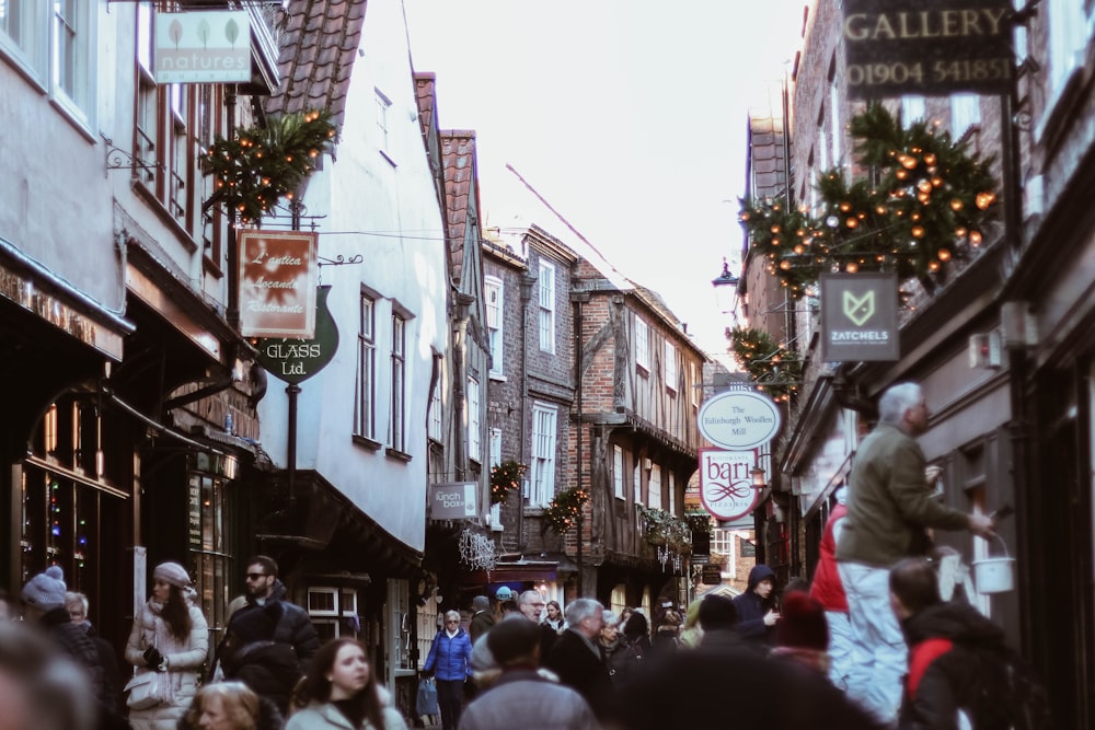 group of people walking near establishments