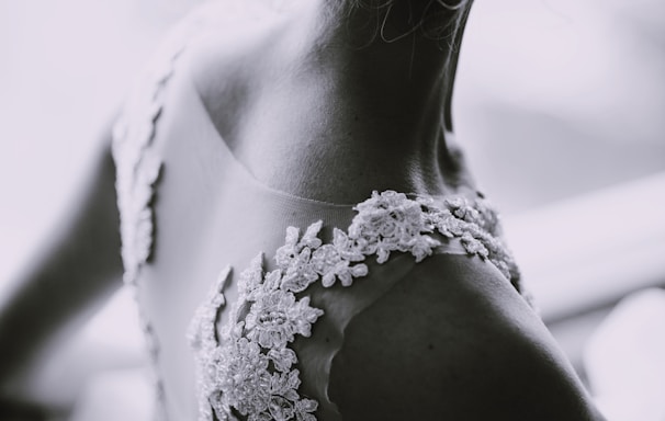 grayscale photography of a woman in lace sleeveless dress