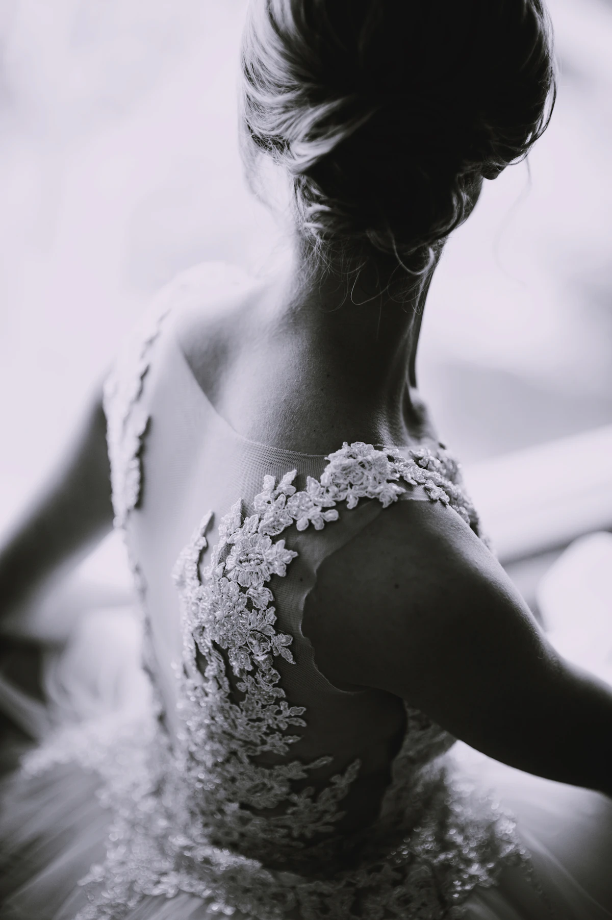 Black and white portrait of a bride in a delicate lace gown