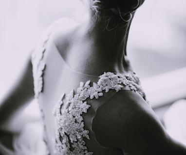 grayscale photography of a woman in lace sleeveless dress