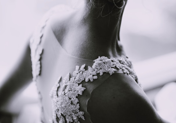 grayscale photography of a woman in lace sleeveless dress
