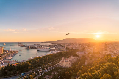 Aerial view of Tangier city with the cruise port and Mediterranean Sea glowing under warm golden light.