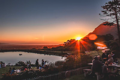 Scenic view of a small, intimate group enjoying a sunset overlooking a pristine lake.