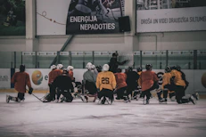hockey coach in front of hockey player