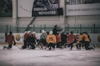hockey coach in front of hockey player