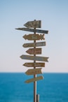 brown wooden road sign during daytime