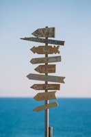 brown wooden road sign during daytime