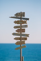 brown wooden road sign during daytime